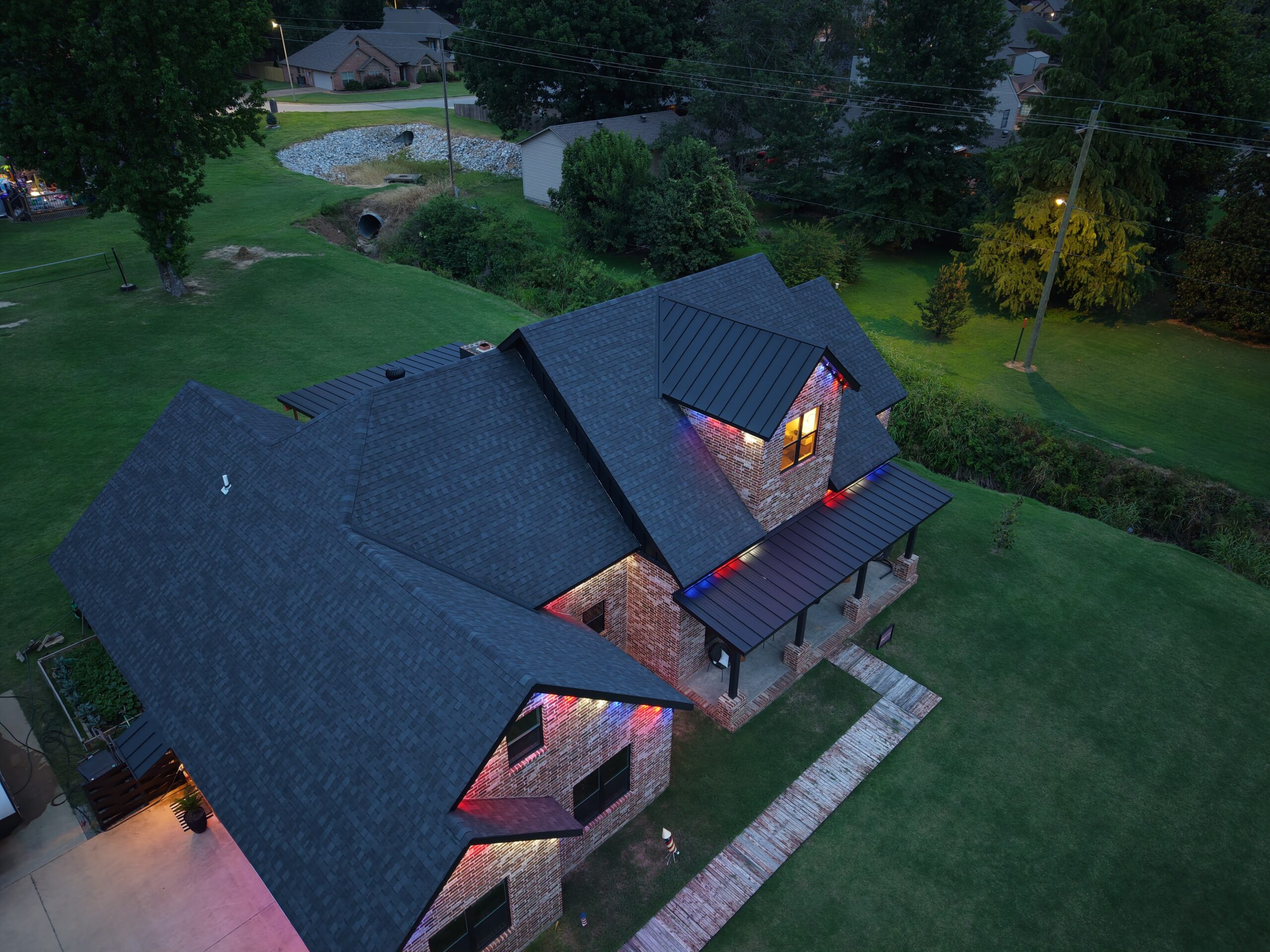 home with exterior lighting and metal porch awning